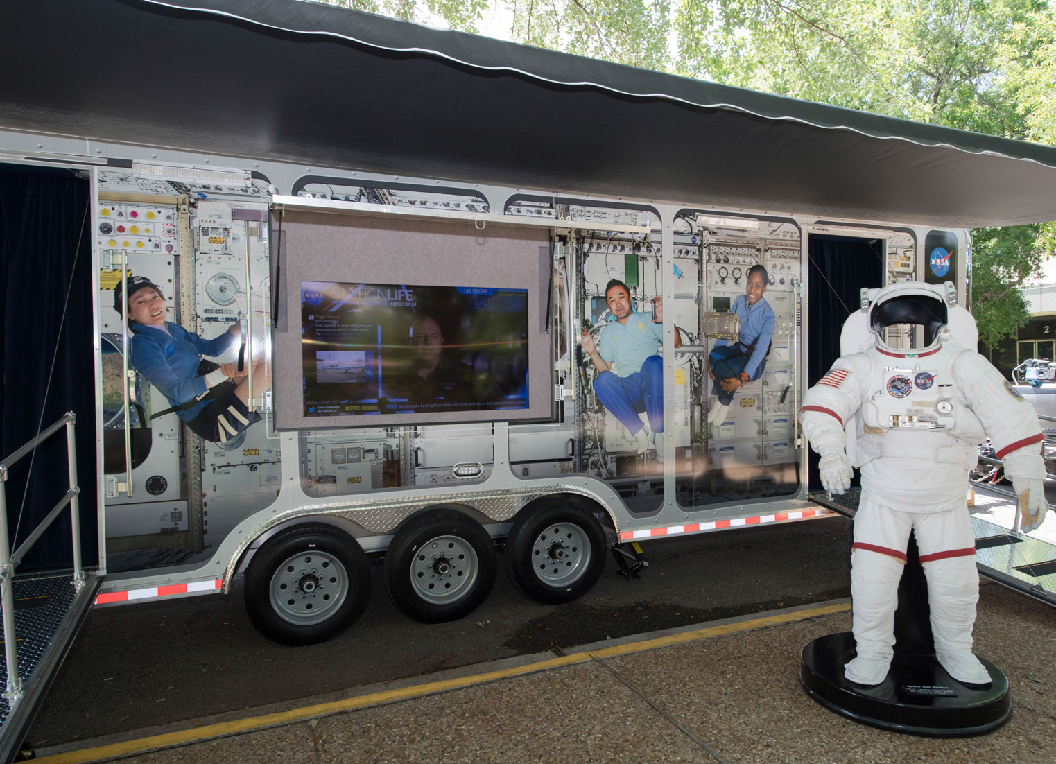 NASA mobile vehicle with an astronaut suit up front.